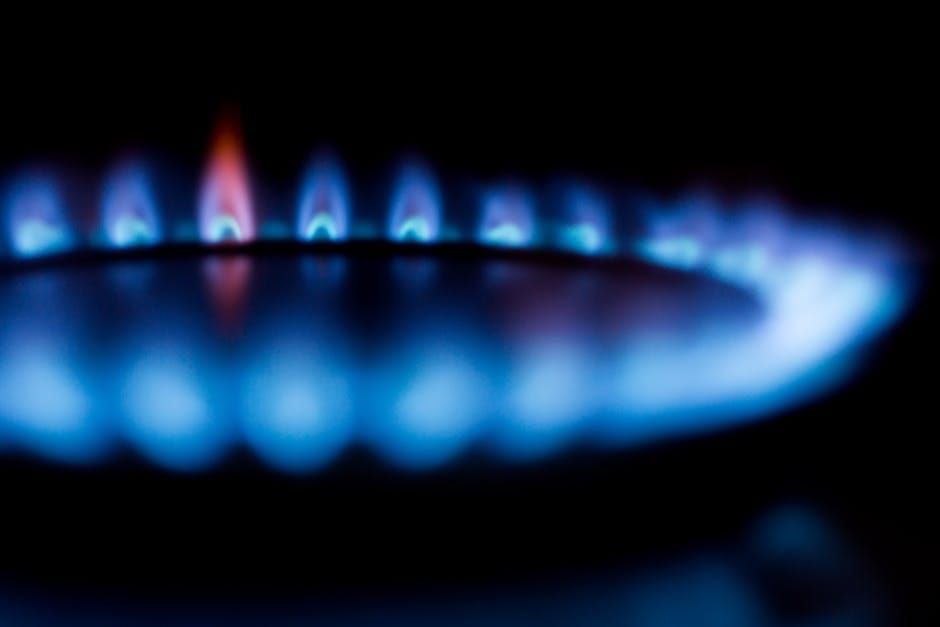 Blurred image of a blue gas stove flame, highlighting heat and energy.